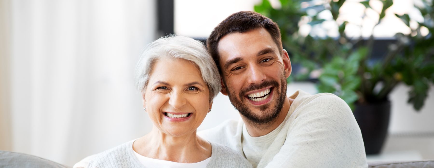 young man beside elderly woman
